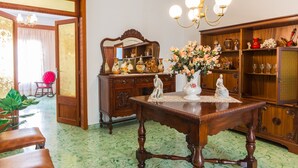 A traditional room with a wooden dining table, a mirror, and a cabinet with glass doors. - YourHouse Ca Na Fonoy (Santa Margalida)
