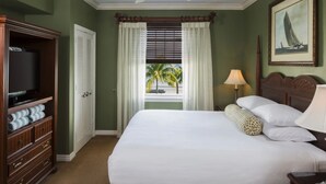 A hotel room with a large bed, a television on a wooden cabinet, a window with curtains, and a painting on the wall. - Hyatt Vacation Club at Windward Point Key West (Key West)