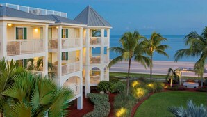 A multi-story hotel with balconies, a beach view, and well-maintained landscaping. - Hyatt Vacation Club at Windward Point Key West (Key West)
