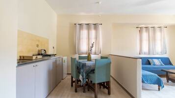 Mini-fridge, stovetop, electric kettle, cookware/dishes/utensils