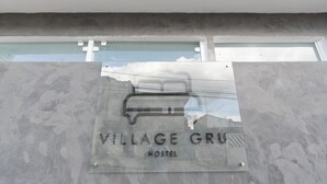 A sign for 'Village Gru Hostel' with a clear view of the building's exterior. - Hostel Village GRU (Guarulhos)