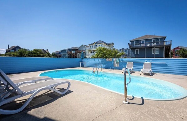 Relax by the pool surrounded by comfortable lounge chairs.