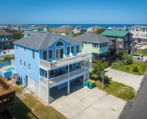 Relax on the upper-floor balcony overlooking a well-maintained lawn.