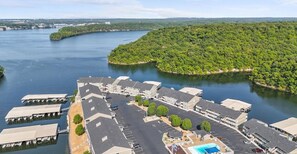 A waterfront hotel with multiple buildings, a parking lot, and a swimming pool. - Waterfront Condo Lake of the Ozarks Surrounded by State Park Boat Slip available (Osage Beach)