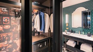 A bathroom with a vanity, a mirror, and a towel rack. - aileenhotel (seoul)