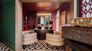 A hotel lobby with a check-in counter, seating area, and vintage suitcases. - aileenhotel (seoul)