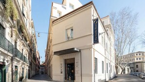 A hotel with a classic European facade, a prominent entrance, and a clear view of the street. - aileenhotel (seoul)