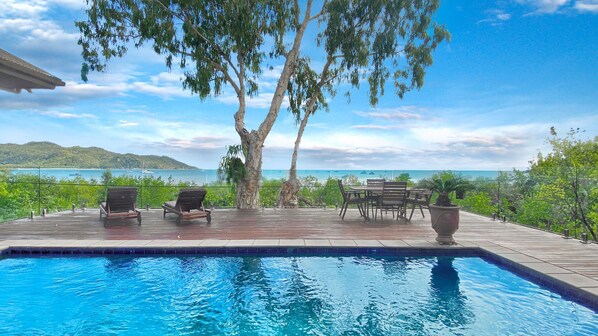 Enjoy ocean views and relax by the pool on the spacious deck.