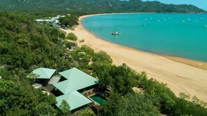 Enjoy a tranquil beachside retreat with a view of the turquoise sea from the shaded building.
