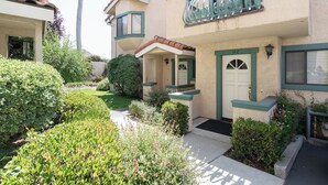 A two-story house with a front porch, a mailbox, and a well-maintained garden. - 1277 Belridge Apt14C-Monthly (Oceano)