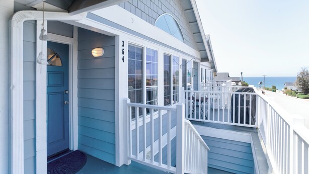 A coastal building with a blue exterior, white railings, and a visible number '364'. - 364 Harbor View (Pismo Beach)