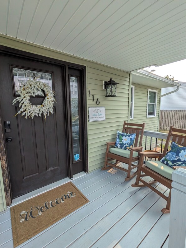 A front door with a wreath, a welcome mat, and a number sign. - 4-bedroom Beach House in charming North Cape May- OUTDOOR SPACE UPDATED IN 2026! (Lower Township)
