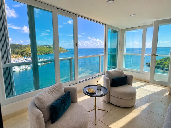 A spacious balcony with a clear view of the sea and a distant island. - Caribbean Dream Condo – Oceanfront, Mountain Views & Modern Comfort (Fajardo)