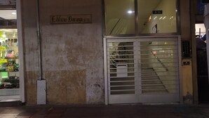 A storefront with a metal gate and a sign above it. - Downtown private apartment (Bogotá)