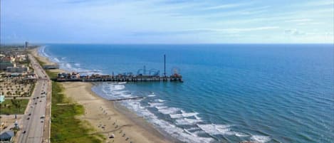 Enjoy a serene beachside retreat with access to a tranquil ocean and a scenic pier.