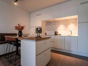 Enjoy cooking and socializing in this kitchen with a central island, wine bottle storage, and a coffee machine.