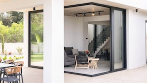 A modern interior with a sofa, coffee table, and staircase.