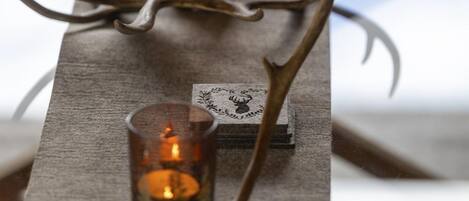 A candle holder with a deer head design and two candles.