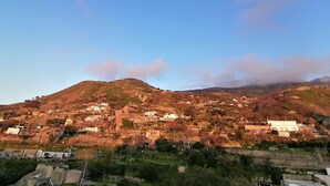 A mountainous landscape with scattered buildings, likely a small town or village. - APARTMENT IN QUIET AREA, MINUTES FROM SPA PARKS AND BEACH, (FORIO)