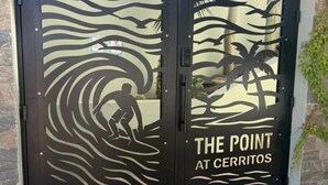 A double door with a sun and palm tree design, and the text "THE POINT AT CERRITOS". - Surf Paraiso @The Point (Los Cerritos, El Pescadero)