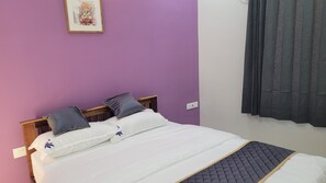 Cozy retreat with a single bed, nightstand, and framed picture.