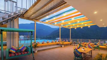 An aesthetically lit terrace with city views.