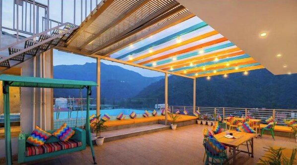 An aesthetically lit terrace with city views. - goSTOPS PLUS Rishikesh, Tapovan (Rishikesh)