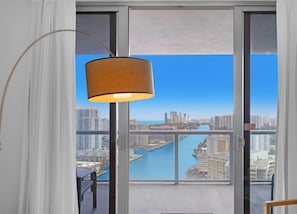 A balcony with a view of a city skyline and a river.