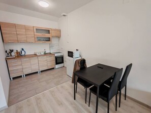 Apartment, 1 Bedroom, Smoking, Balcony | Dining room - Workstay Apartment Modern Comfort With Private Parking, Near City Amenities (Kecskemet)