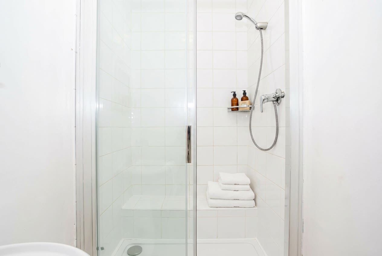 Shower, hair dryer, towels, shampoo