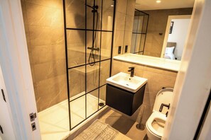 Shower, hair dryer, towels, shampoo