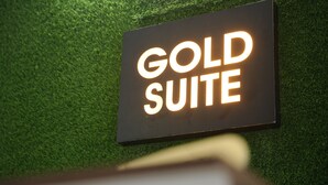 A sign with the words "GOLD SUITE" illuminated on a dark background. - Goldsuite (Kanayannur)
