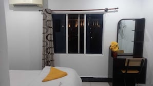 A bedroom with a bed, a window, a mirror, and a dresser. - Hotel Selver Shinn & Restaurant (Phnom Penh)
