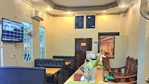 A lobby with a reception desk, seating area, and a security camera. - Hotel Selver Shinn & Restaurant (Phnom Penh)