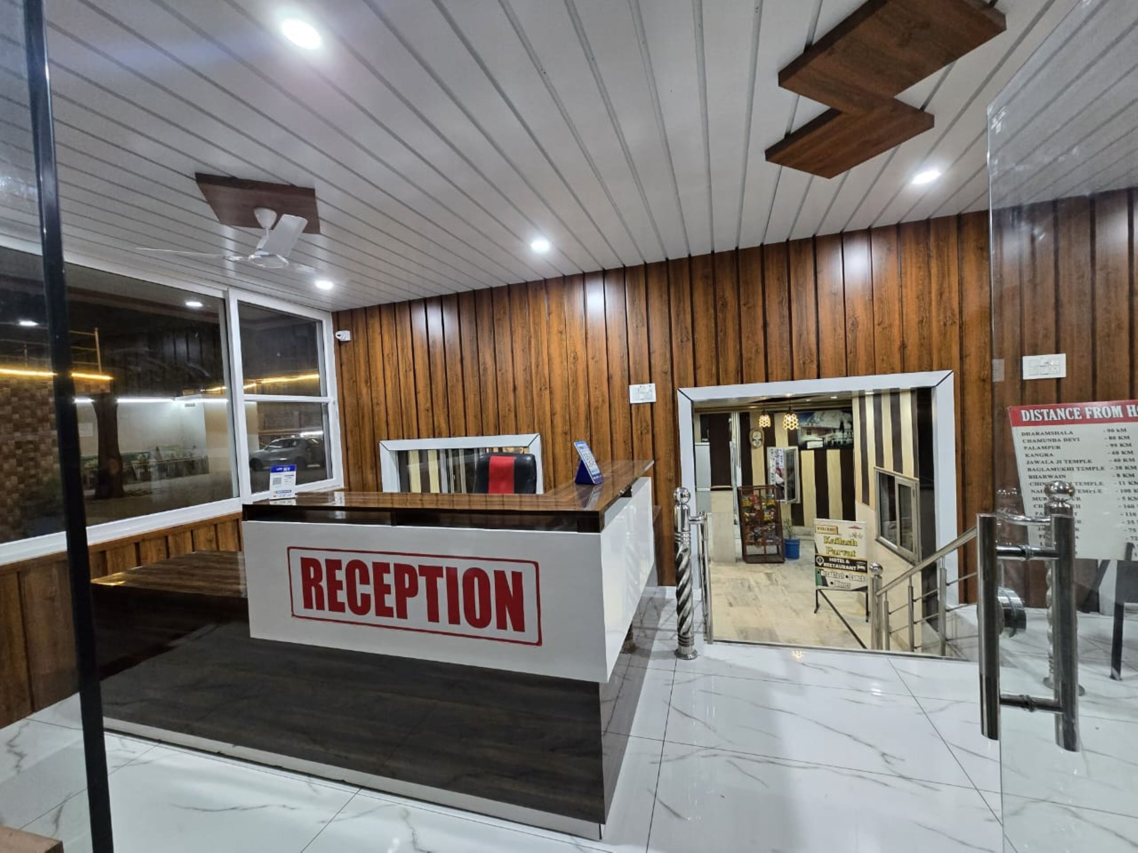 A reception area with a wooden wall and a reception desk labeled "RECEPTION".