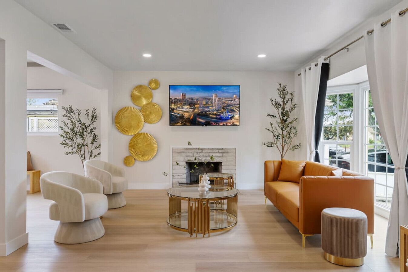 A modern living room with a fireplace, a round coffee table, and a sofa.