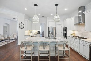 Enjoy cooking in this well-lit kitchen with a large island and stainless steel appliances.
