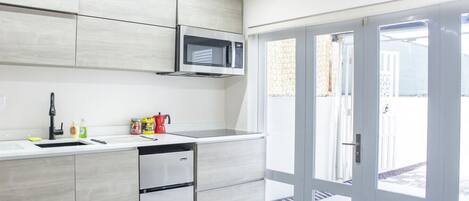 Microwave, stovetop, coffee/tea maker, cookware/dishes/utensils