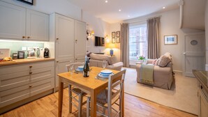 A compact living space with a kitchen, dining area, and seating area. - Elegant Couples' Escape in Dartmouth (Dartmouth)