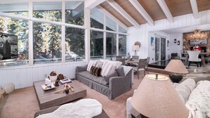 A spacious living area with a large window, a fireplace, and a cozy seating arrangement.