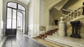 A grand staircase with marble steps and ornate balustrades, leading to an upper floor. - RAMBLA CATALUNYA SKY (Barcelona)