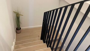 A staircase with wooden steps and a black railing. - One Lux Stay Near Antwerp Central Grande Deluxe 3 Bedroom Suite (Antwerp)