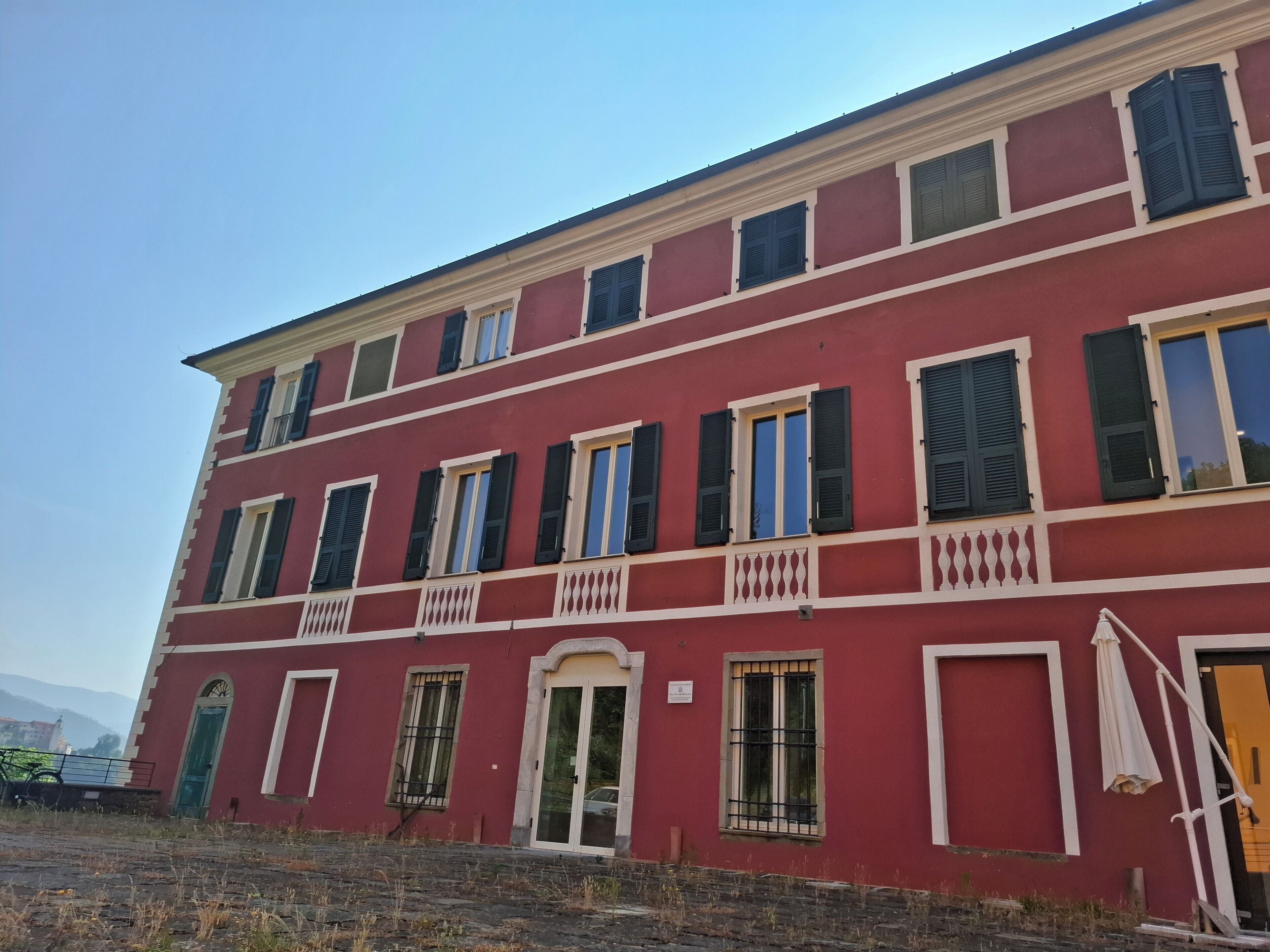 A red building with multiple windows and balconies.