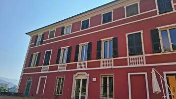 A red building with multiple windows and balconies.