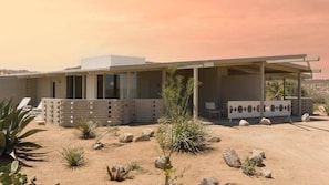 A modern house with a covered porch, desert landscaping, and a clear sky. - The Bungalows by Homestead Modern, Premium Double (Joshua Tree)