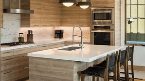 A modern kitchen with a central island, stainless steel appliances, and wooden cabinetry. - New Remodel Old Town House by InvitedHome | Walk to Town, Ski, Hot Tub, Patio (Park City)