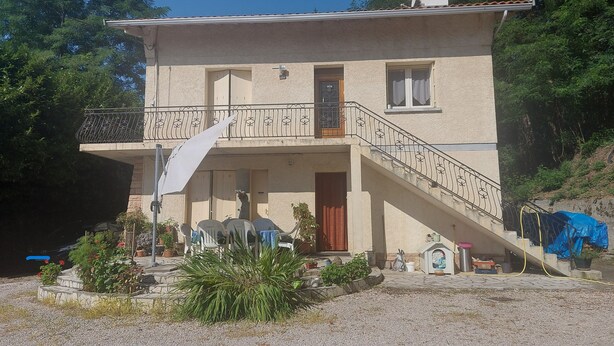 A two-story house with a balcony, a staircase, and a front door. - Country apartment close to the forest. You can go for a nice walk, (Boussens)