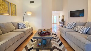 A living room with two sofas, a coffee table, and a TV.
