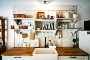 Enjoy cooking and cleaning in this well-equipped kitchen with a sink and stove.