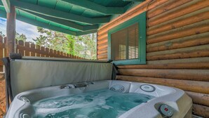 A wooden cabin with a hot tub.